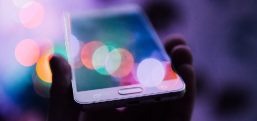 Person holding a smartphone to withdraw money via mobile money